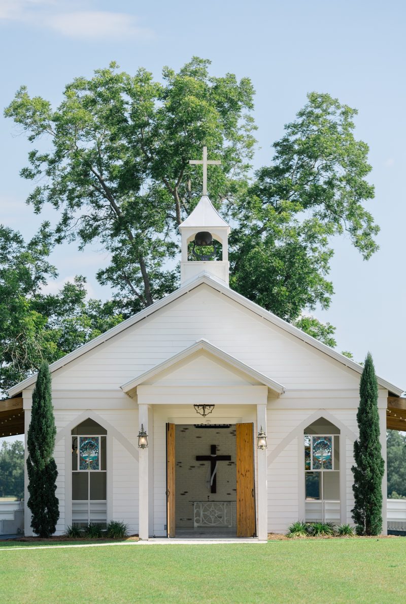 White chapel with a cupola under a blue summer sky