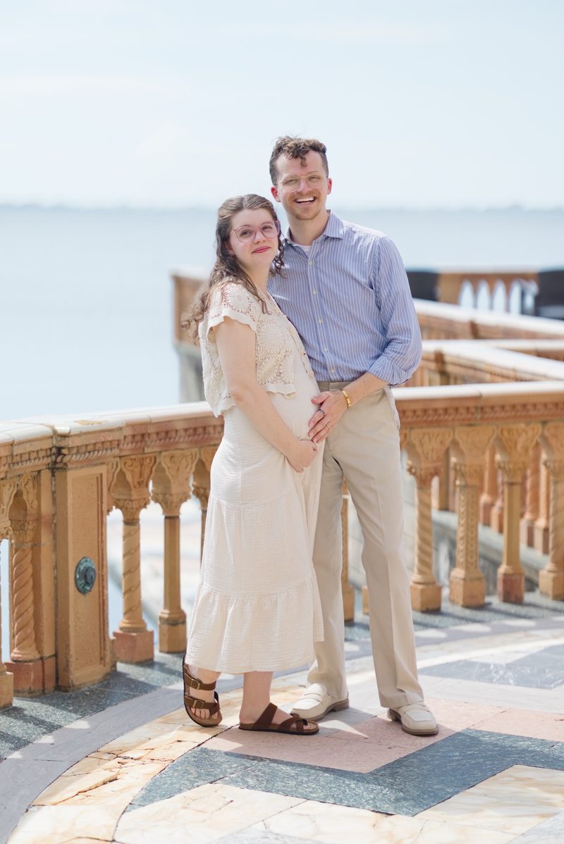 Grant and Morgan stand together on a terracotta balustrade above the bay