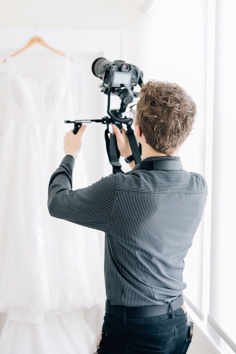 Behind the scenes: filming the wedding dress hanging by a bright window