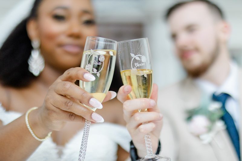 Bride and groom raise champagne flutes in a toast
