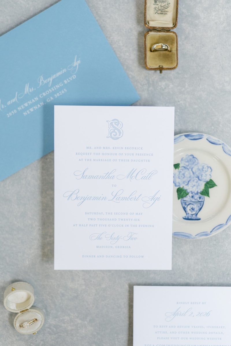 Wedding invitation suite with blue envelope, rings and a ring box